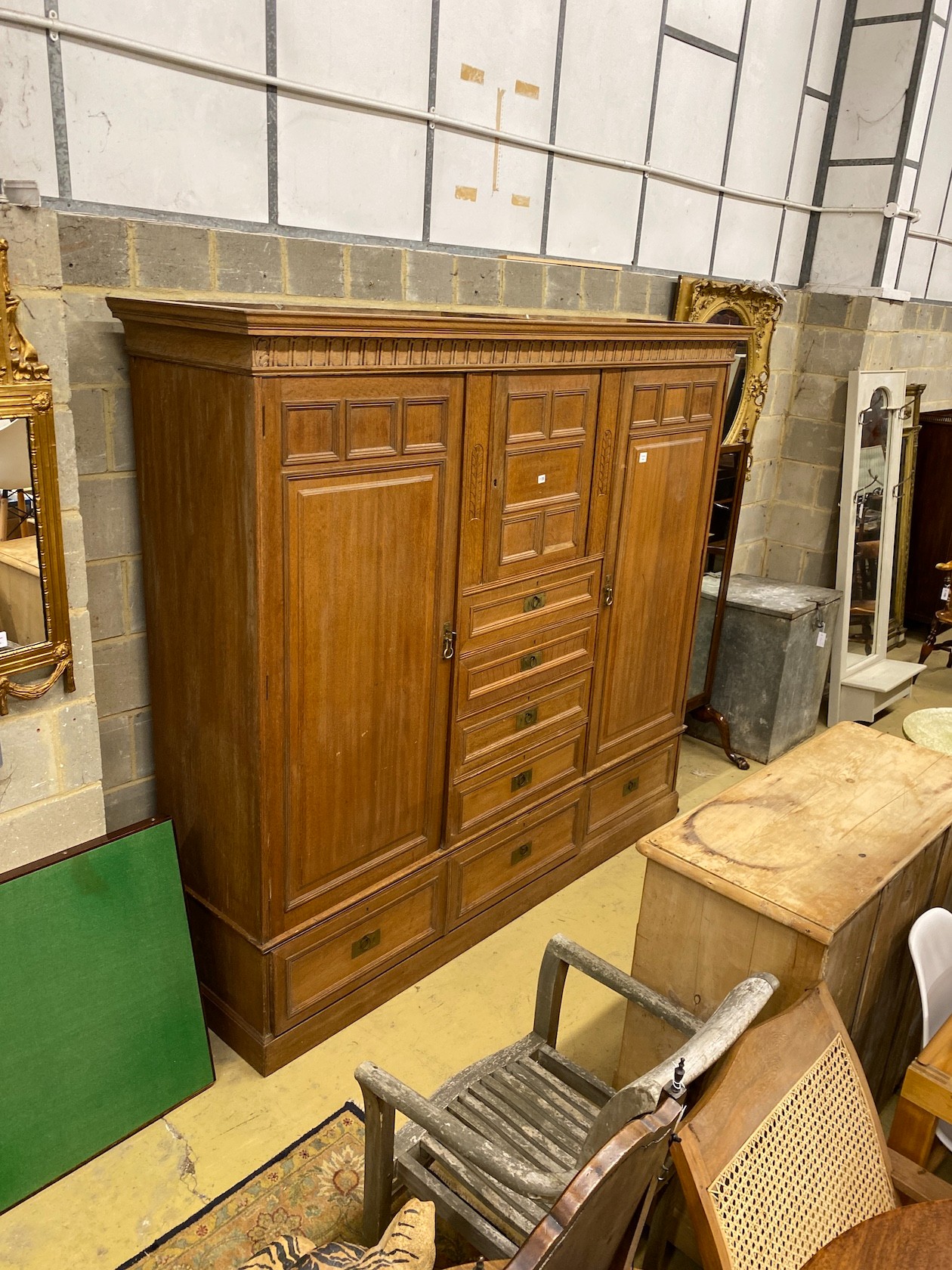A late 19th century German Art Nouveau oak compactum wardrobe, length 224cm, depth 56cm, height 204cm